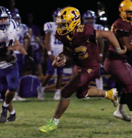 MASON HINES | DISPATCH RECORD Lukas Smailus-Cruz (22) looks for space during a hard run. Smailus-Cruz led the Hornets in rushing with 178 yards and three scores.