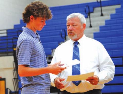 Nate Borchardt receives his certificate from coach Justin Reeves. HUNTER KING | DISPATCH RECORD