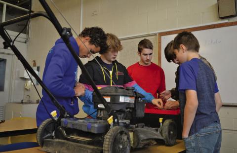 Lampasas Middle School students work on running diagnostics with a lawnmower Friday morning during their small-engines class. ERICK MITCHELL | DISPATCH RECORD
