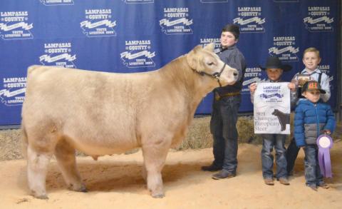 Ridge Hill, (in center, next to steer), is shown with his brothers Trigg, Housten and Judd.