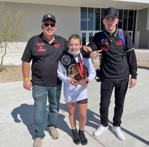 Taylor Martell, center, shows the bronze medal she earned in Arizona. 