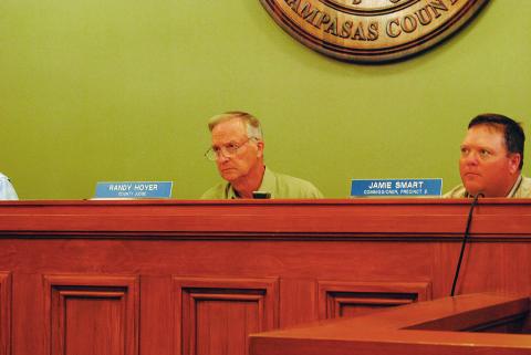 County Judge Randy Hoyer and Commissioner Jamie Smart listen to discussion on the county's burn ban. 