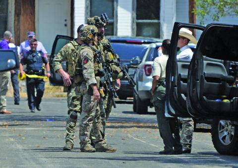 Texas DPS Swat stands by as Lampasas Police tape a perimeter around the incidence scene.