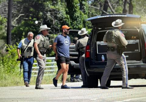 Officers escort a suspect away from his vehicle. 