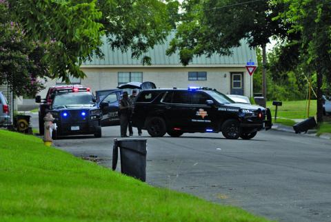 Lampasas Police and Texas DPS vehicles can be seen on a city block. 