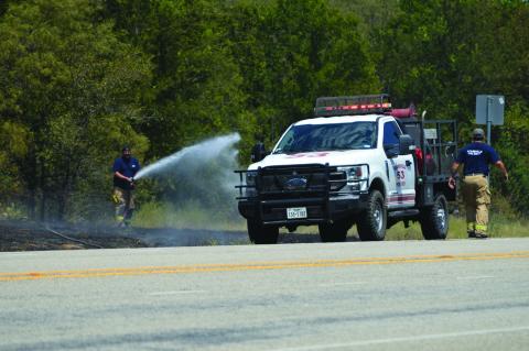 Adamsville Volunteer Fire Department firefighters work to extinguish a grass fire along U.S. Highway 281, about five miles south of Adamsville. ERICK MITCHELL | DISPATCH RECORD 