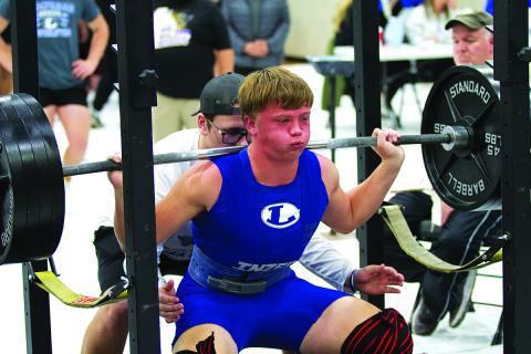 Carter Kuhn squats during the recent home powerlifting meet. 