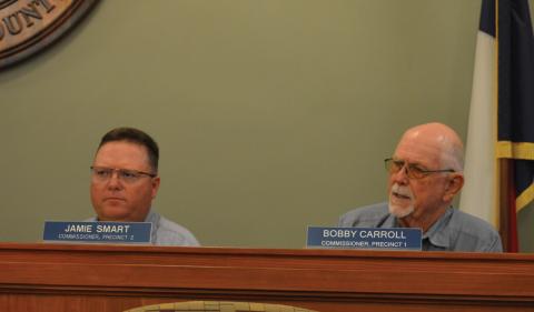 From left, Precinct 1 Commissioner Jamie Smart and Precinct 2 Bobby Carroll talk flood damage during today's Lampasas County Commissioners Court regular meeting. ERICK MITCHELL | Dispatch Record
