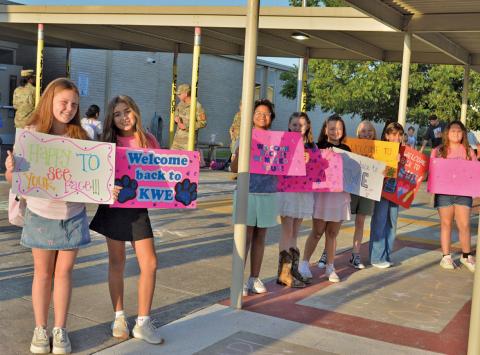 Kline Whitis students, from left, Jentry Jones, Christianna Gonzalez, Nikita Olsen, Kylee Davis, Hazel Cecil, Nadia Martin, Brooklyn Alderson, and Autumn Hiller welcome classmates on the first day of school. erick mitchell | dispatch record