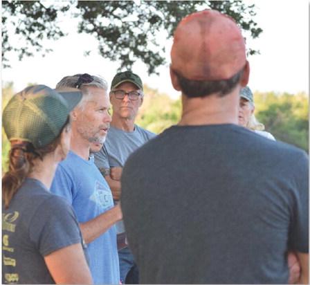 Kristi Allison and Shannon Martin, at left, address a group of volunteers gathered to prep the trail corridors on Saturday morning. ALEXANDRIA RANDOLPH | DISPATCH RECORD