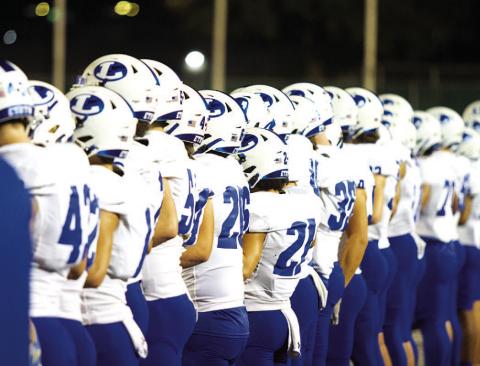HUNTER KING | DISPATCH RECORD The Badger football team stands on the sideline prior to the start of their area-round playoff game against Alice.