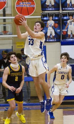 Carter Johnson (33) recovers the ball after blocking a three-pointer in the fourth quarter, while Nate Borchardt (0) goes in transition. JEFF LOWE | DISPATCH RECORD
