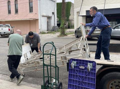 Shown left to right are Chance Carter, Rudy Rodriguez and Keith Russom as they load the antique hospital bed onto a flatbed for transport from the museum to the hospital. courtesy photo