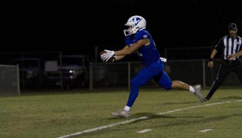 Ethan Moreno reaches for the goal line for one of his four touchdowns of the night during the Badgers’ rout of Elgin on Friday. HUNTER KING | DISPATCH RECORD
