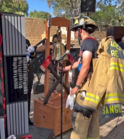 courtesy photo Hunter Sanguinet, a firefighter for the communities of Leander and Lampasas, rings the ceremonial bell upon completing the San Antonio 110. The bell toll memorializes a fallen first responder.