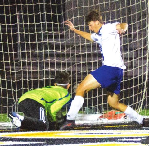 Landon Richardson pokes a goal home during the Badgers’ playoff matchup last year. FILE PHOTO