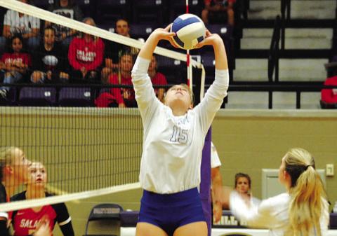 Ava Dowdy sets the ball for Breana Pelbath during Tuesday’s playoff match. HUNTER KING | DISPATCH RECORD