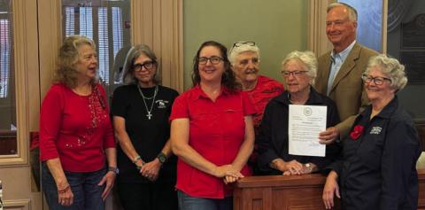 ERICK MITCHELL | DISPATCH RECORD County Judge Randy Hoyer presents a Poppy Day proclamation from the Lampasas County Commissioners Court to a group of representatives from the Briggs-Wright American Legion Post 277 Auxiliary of Lampasas. Poppy Day will be recognized May 22, when residents are invited to wear a red poppy to honor those who lost their lives fighting for our freedom.