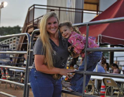Friday’s Riata Roundup Rodeo provided a night of family fun. From left, Kaila and Wren Rogers pose for a photo just outside the 580 Sports Park rodeo arena. ERICK MITCHELL | DISPATCH RECORD