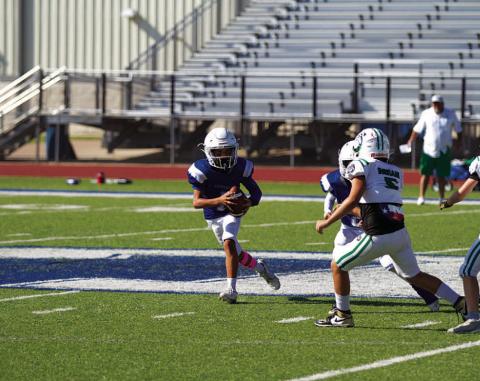 Kaylor Chapa rolls to his right during a BBYL game. HUNTER KING | DISPATCH RECORD