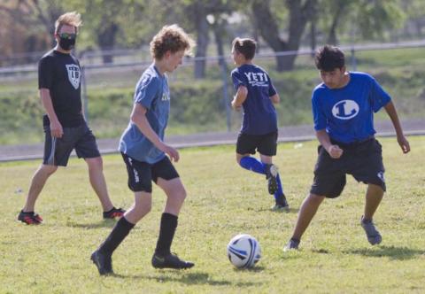 Coach Edward Gold, far left, watches Solomon Storm and Alex Montiel, far right, go through a drill on Tuesday while Tate Langford, back-center, jogs back to a line. JEFF LOWE | DISPATCH RECORD