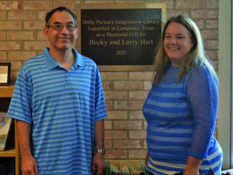 Tyler Byrd and his sister Elizabeth Byrd pose for a photo with the plaque honoring their late parents, Becky and Larry Hart. A donation from Elizabeth in honor of her parents helped launch the Dolly Parton’s Imagination Library program in Lampasas in 2021. ERICK MITCHELL | DISPATCH RECORD