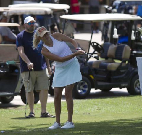 Carmen Gonzalez follows through on a shot during the chipping contest on Saturday. HUNTER KING | DISPATCH RECORD