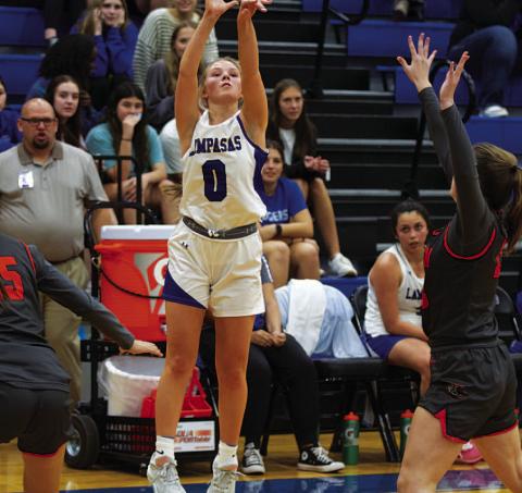 Addison Borchardt shoots a three-point shot over a defender. HUNTER KING | DISPATCH RECORD