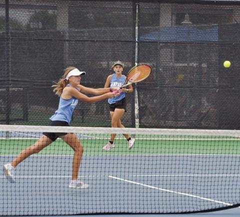 COURTESY PHOTO | KENNETH PEISER Madelynn White reaches for a shot as Caroline White watches her sister.