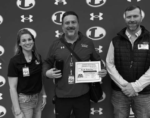 Assistant Principal Kristin Montague and Clay Phillips of Texas Farm Bureau Insurance were on hand to recognize Heath Hohmann as Teacher of the Month for December. COURTESY PHOTO