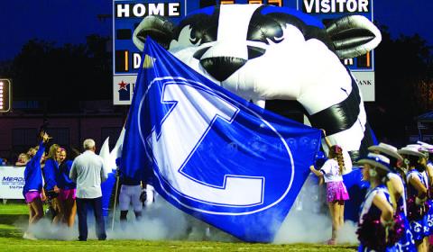 Smoke flies out of the tunnel before the Badgers take the field. HUNTER KING | DISPATCH RECORD