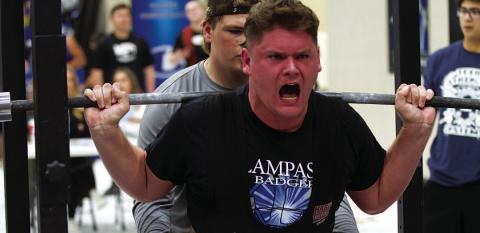 Deegan Norwood strains to lift during the squat portion of last week’s powerlifting meet. HUNTER KING | DISPATCH RECORD