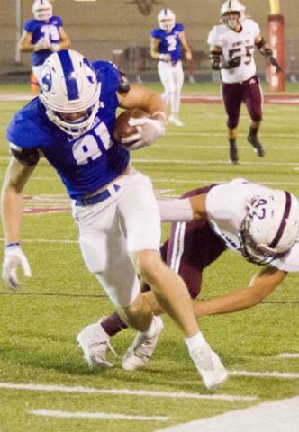Receiver Carter Johnson stays in bounds on a reception as he is hit by a Uvalde Coyote. JEFF LOWE | DISPATCH RECOR