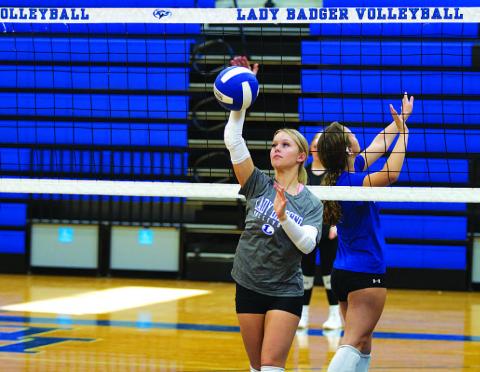 HUNTER KING | DISPATCH RECORD Scout Barton warms up during the first fall practice for the volleyball season.