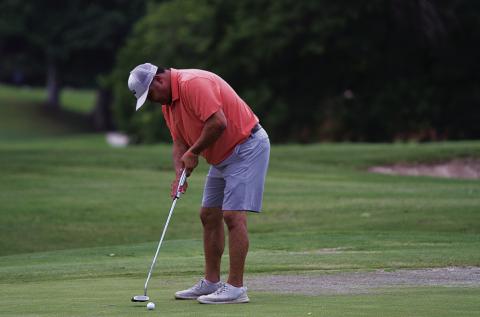 Harvey Stinnett hits a putt during the KM two-man scramble at Hancock Park Golf Course last Friday. HUNTER KING | DISPATCH RECORD