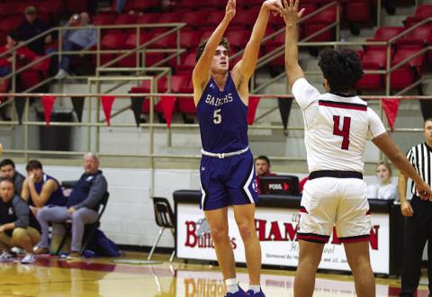 Trent Seneca shoots a three-point shot over a defender. HUNTER KING | DISPATCH RECORD