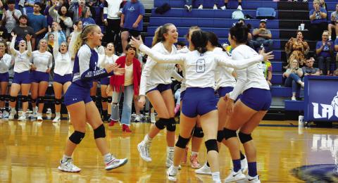 HUNTER KING | DISPATCH RECORD The Lady Badgers celebrate after a point in the third set against Gatesville on Tuesday.
