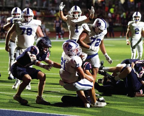 HUNTER KING | DISPATCH RECORD KJ Reed extends toward the goal line to score the late touchdown that gave the Badgers the lead against Wimberley.