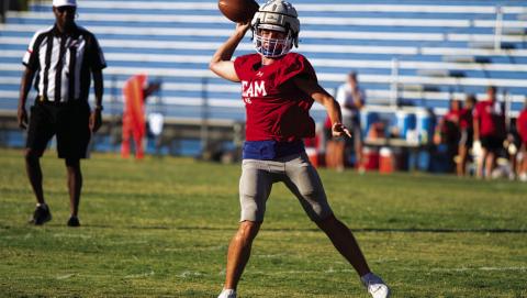HUNTER KING | DISPATCH RECORD JT Posten rolls to his right and throws into the flat during last Friday’s scrimmage.
