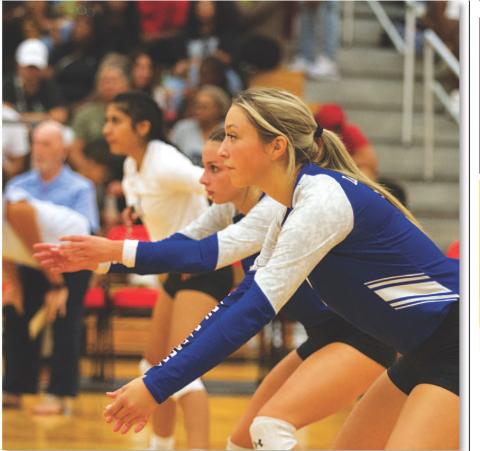 Brailey Wilson, Landry White and Arielle Aguire await a serve. HUNTER KING | DISPATCH RECORD
