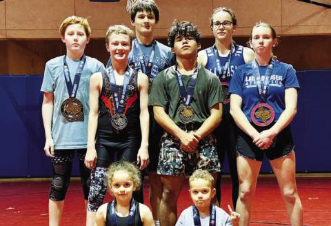 These young wrestlers pose with their medals from the recent tournament. HUNTER KING | DISPATCH RECORD