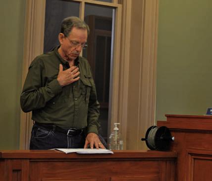 Mike Watson checks his notes while making a presentation to the Commissioners Court on managementneedsoftheSaratogaUnderground Water Conservation District. ERICK MITCHELL | DISPATCH RECORD