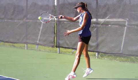 HUNTER KING | DISPATCH RECORD Chesley Breuer hits a forehand shot during her singles match.
