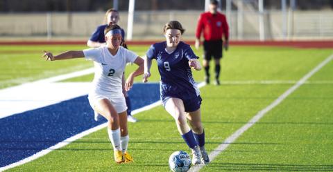 HUNTER KING | DISPATCH RECORD Bella Lindsey dribbles down the sideline against Academy. She scored four goals in the match.