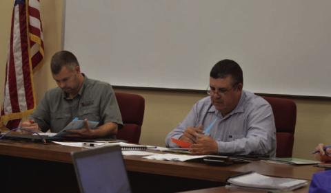 At left, Lampasas Central Appraisal District Board Chairman Marshal Brewer and Board Member Chris Harrison review the 2025 proposed budget amendments during Thursday’s meeting. ERICK MITCHELL | DISPATCH RECORD