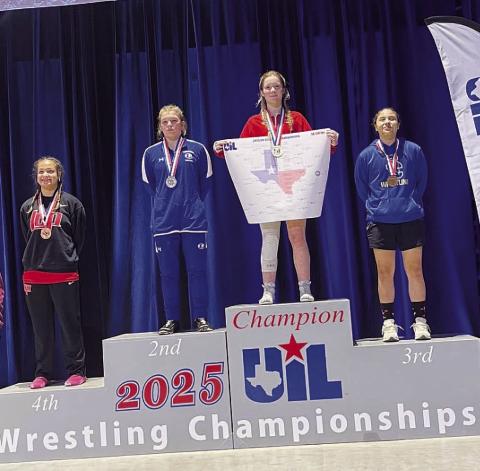 COURTESY PHOTO | DONOVAN KLECKNER Taylor Martell stands on the second-place spot of the podium at the state wrestling meet.