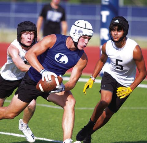 Jett Walker lunges toward the corner of the end zone during Tuesday’s 7-on-7 competition. HUNTER KING | DISPATCH RECORD