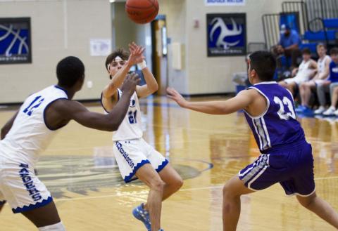 Austin Wilson lofts a pass to Johnki Gardner off a pick-and-roll, and Gardner went to the basket to finish last Monday. HUNTER KING | DISPATCH RECORD