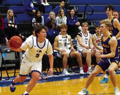 Aidan Nuckles dribbles past a Lago Vista defender. He scored 11 points in Tuesday’s game. HUNTER KING | DISPATCH RECORD