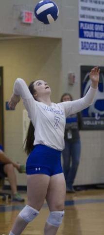 Bella Lindsey reaches up to send over a serve during the last non-district match for the Lady Badgers. HUNTER KING | DISPATCH RECORD